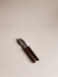 A small hand tool with dark brown wooden handles and a silver metal head, photographed on a plain light beige background.